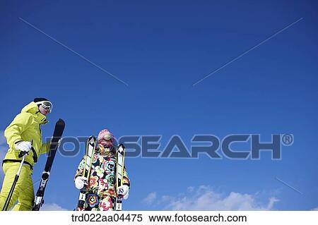 The man and woman wearing skiwear with the ski gear View Large Photo Image Stock Photography - The man and woman wearing skiwear with the ski gear. Fotosearch