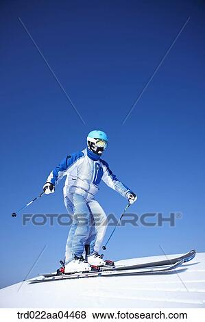 Stock Photo - The man skiing on the slope. Fotosearch