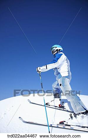 The man wearing skiwear and gear on the slope View Large Photo Image Stock Photo - The man wearing skiwear and gear on the slope. Fotosearch