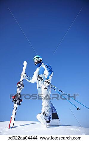 The man wearing skiwear with the ski poles and ski boards View Large Photo Image Picture - The man wearing skiwear with the ski poles and ski boards. Fotosearch