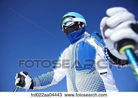 The man wearing skiwear with the ski poles View Large Photo Image Stock Image - The man wearing skiwear with the ski poles . Fotosearch