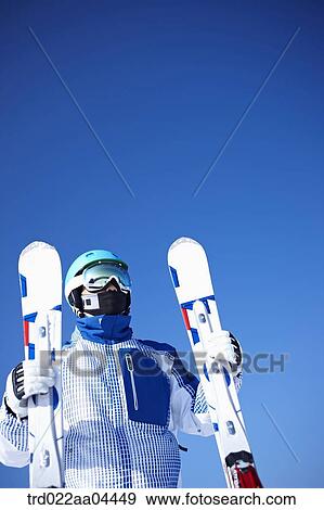 The man wearing skiwear with the ski boards View Large Photo Image Stock Photo - The man wearing skiwear with the ski boards. Fotosearch
