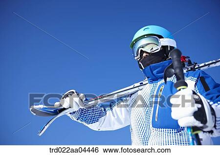 The man wearing skiwear with the ski poles and ski boards View Large Photo Image Stock Photograph - The man wearing skiwear with the ski poles and ski boards. Fotosearch
