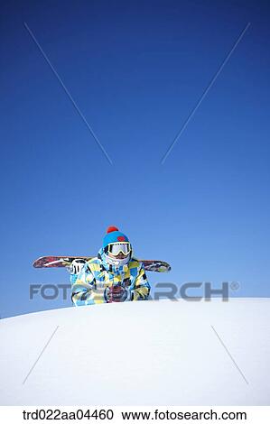 The man wearing snowboarding wear and gear on the slope View Large Photo Image Stock Image - The man wearing snowboarding wear and gear on the slope. Fotosearch