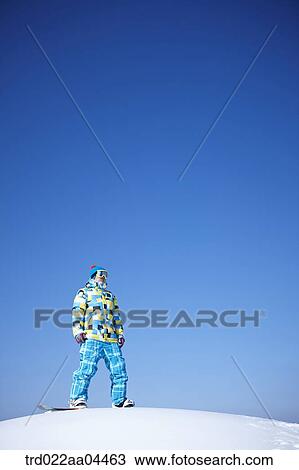 The man wearing snowboarding wear and gear on the slope View Large Photo Image Stock Image - The man wearing snowboarding wear and gear on the slope. Fotosearch