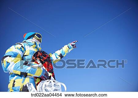 The man wearing snowboarding wear with the snowboard View Large Photo Image Picture - The man wearing snowboarding wear with the snowboard. Fotosearch