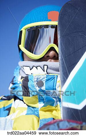 The man wearing snowboarding wear with the snowboard View Large Photo Image Stock Photo - The man wearing snowboarding wear with the snowboard. Fotosearch
