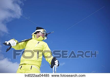 The man with the ski boards on his shoulder View Large Photo Image Stock Photography - The man with the ski boards on his shoulder. Fotosearch