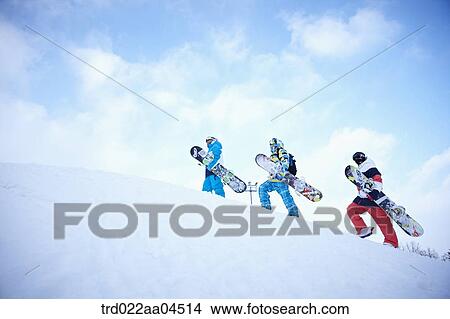 The people climbing the slope with the snowboards View Large Photo Image Picture - The people climbing the slope with the snowboards. Fotosearch