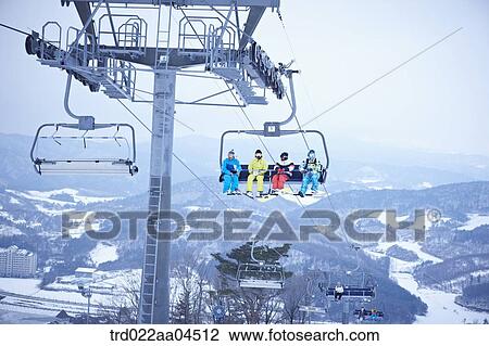 The people wearing the ski gear on the lift View Large Photo Image Stock Image - The people wearing the ski gear on the lift. Fotosearch