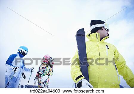 Stock Photo - The people wearing the ski wear with the ski gear. Fotosearch