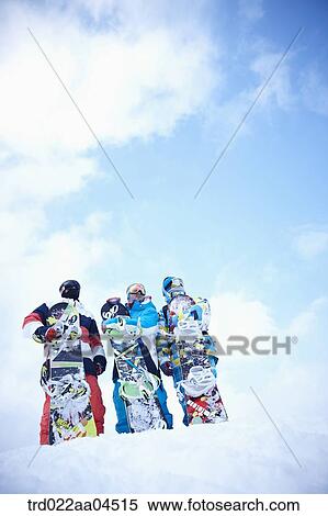 The people wearing the snowboarding wear with the snowboards View Large Photo Image Stock Photography - The people wearing the snowboarding wear with the snowboards. Fotosearch