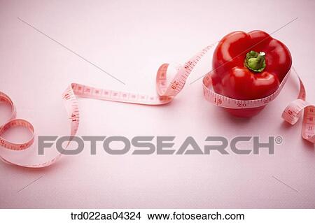 The red bell pepper tied with the tape measure View Large Photo Image Picture - The red bell pepper tied with the tape measure. Fotosearch