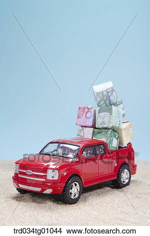 Picture - The red truck loading the foreign currency blocks. Fotosearch