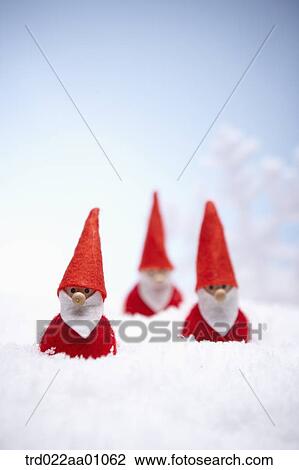 The Santa Claus dolls on the snow View Large Photo Image Stock Image - The Santa Claus dolls on the snow. Fotosearch