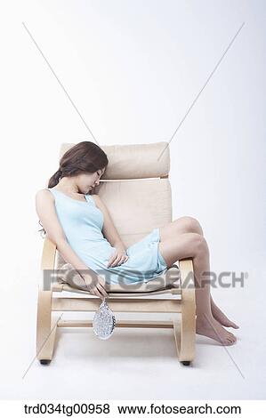 Stock Photo - The sleeping woman on the chair. Fotosearch