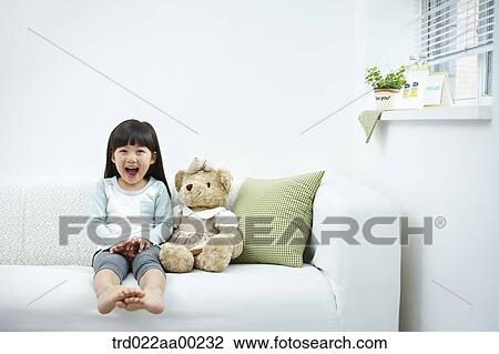 The smiling girl on the white couch View Large Photo Image Stock Image - The smiling girl on the white couch . Fotosearch