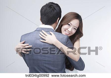 The smiling woman hugging a man in suit View Large Photo Image Stock Image - The smiling woman hugging a man in suit. Fotosearch
