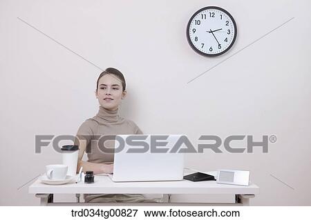 The smiling woman in the office View Large Photo Image Stock Photo - The smiling woman in the office. Fotosearch