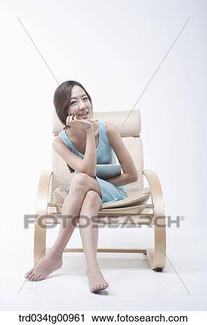 The smiling woman on the chair with the tablet PC View Large Photo Image Stock Image - The smiling woman on the chair with the tablet PC. Fotosearch