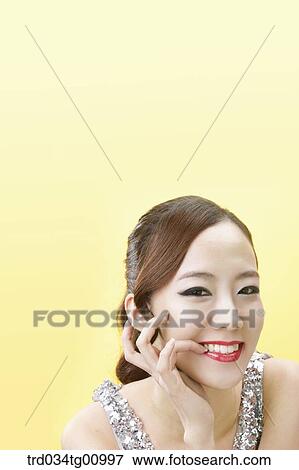 Stock Photo - The smiling woman wearing red lip makeup . Fotosearch