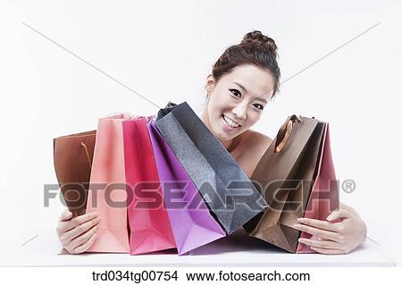 Picture - The smiling woman with shopping bags . Fotosearch