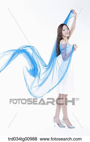 Stock Photo - The smiling woman with the windblown blue cloth. Fotosearch