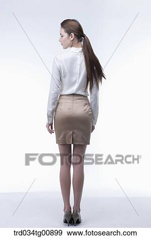 The standing woman from the back View Large Photo Image Stock Photo - The standing woman from the back. Fotosearch