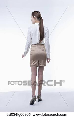 The standing woman from the back View Large Photo Image Stock Photography - The standing woman from the back. Fotosearch