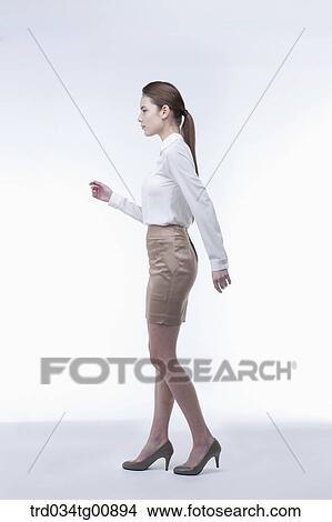 Picture - The standing woman from the side. Fotosearch