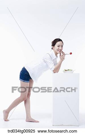 Stock Photography - The standing woman with dish of salad. Fotosearch