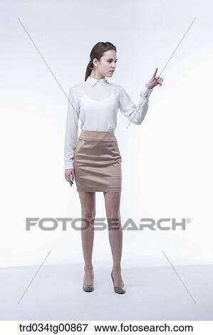 The standing woman with her pointing finger View Large Photo Image Stock Photo - The standing woman with her pointing finger. Fotosearch