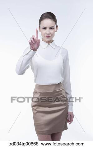 Stock Photo - The standing woman with her pointing finger. Fotosearch