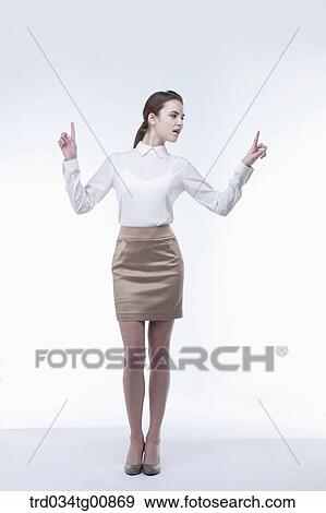 The standing woman with her pointing finger View Large Photo Image Stock Photo - The standing woman with her pointing finger. Fotosearch