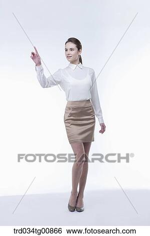 Stock Photograph - The standing woman with her pointing finger. Fotosearch