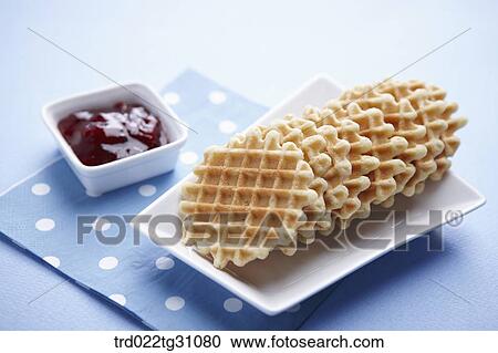 Stock Image - The waffle on the white dish and the jam . Fotosearch