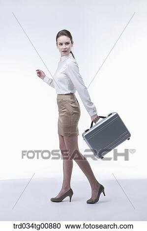 The walking woman with metal suitcase View Large Photo Image Stock Image - The walking woman with metal suitcase. Fotosearch