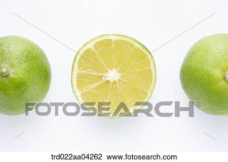Stock Image - The whole limes and a lime in half. Fotosearch