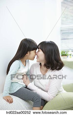 Stock Image - The woman and girl facing each other. Fotosearch