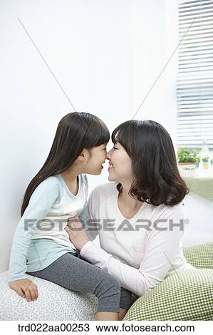 Stock Image - The woman and girl facing each other. Fotosearch