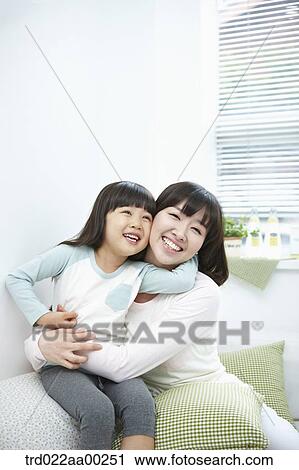 The woman and girl hugging together with big smile View Large Photo Image Stock Image - The woman and girl hugging together with big smile. Fotosearch