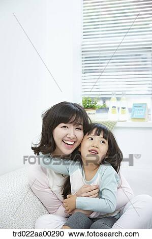 The woman and girl hugging together View Large Photo Image Stock Image - The woman and girl hugging together . Fotosearch