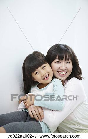 The woman and girl hugging together with big smile View Large Photo Image Stock Photo - The woman and girl hugging together with big smile. Fotosearch