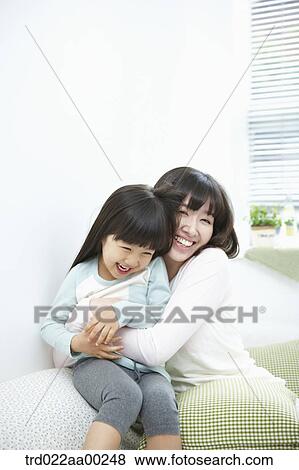The woman and girl hugging together with big smile View Large Photo Image Stock Photo - The woman and girl hugging together with big smile. Fotosearch