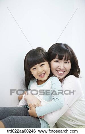 The woman and girl hugging together with big smile View Large Photo Image Stock Photograph - The woman and girl hugging together with big smile. Fotosearch