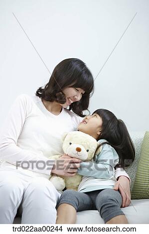 Picture - The woman and girl looking at each other. Fotosearch