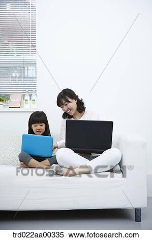 The woman and girl looking at the laptop View Large Photo Image Stock Photography - The woman and girl looking at the laptop . Fotosearch