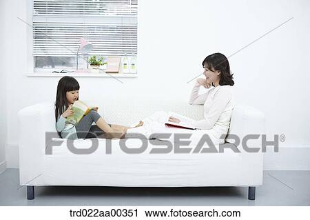 The woman and girl reading the book on the couch View Large Photo Image Stock Image - The woman and girl reading the book on the couch. Fotosearch