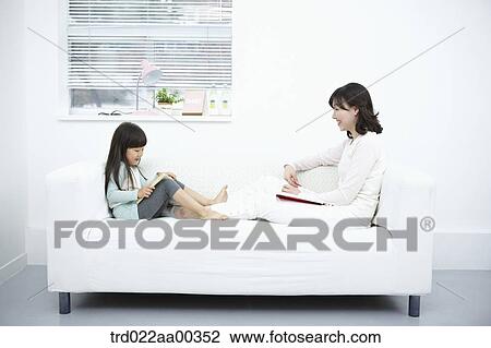 The woman and girl reading the book on the couch View Large Photo Image Stock Image - The woman and girl reading the book on the couch. Fotosearch