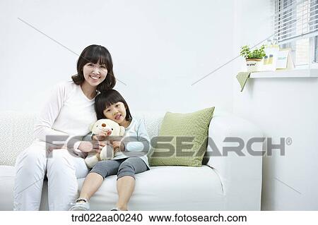 The woman and girl sitting with the teddy bear View Large Photo Image Stock Image - The woman and girl sitting with the teddy bear. Fotosearch